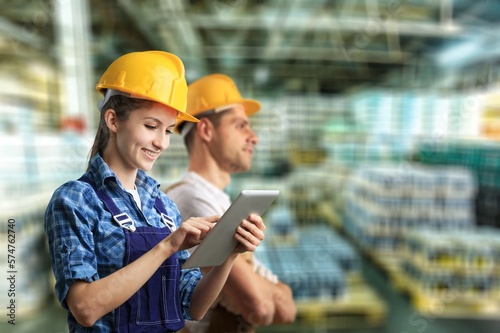 Engineer people check supplies in warehouse.