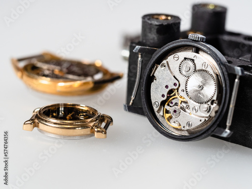 old steel mechanical watch close up on white board in watchmaker workshop