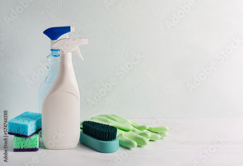 Set of cleaning equipment for cleaning various surfaces on light marble background. Concept of regular cleaning of premises in early spring, house cleaning. Empty space for text or logo. Close-up