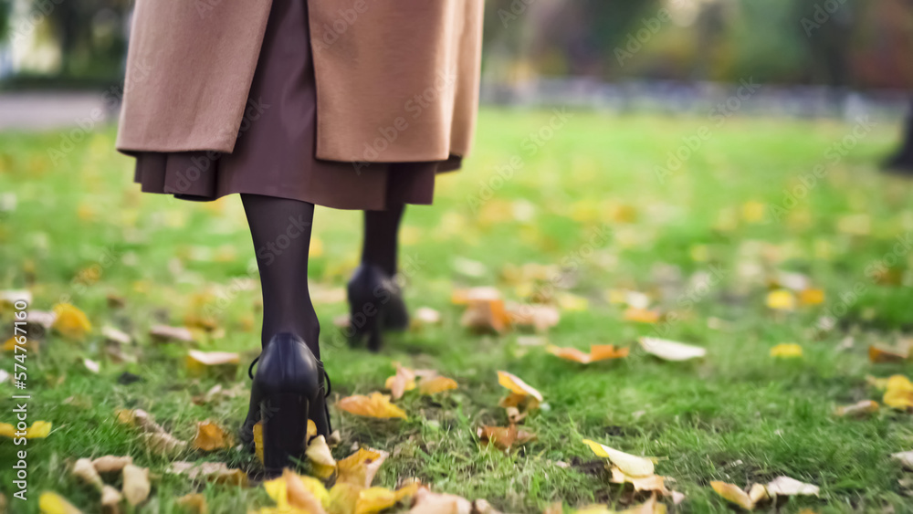 Woman Feet boot walking on fall leaves Woman Feet boot walking on fall leaves