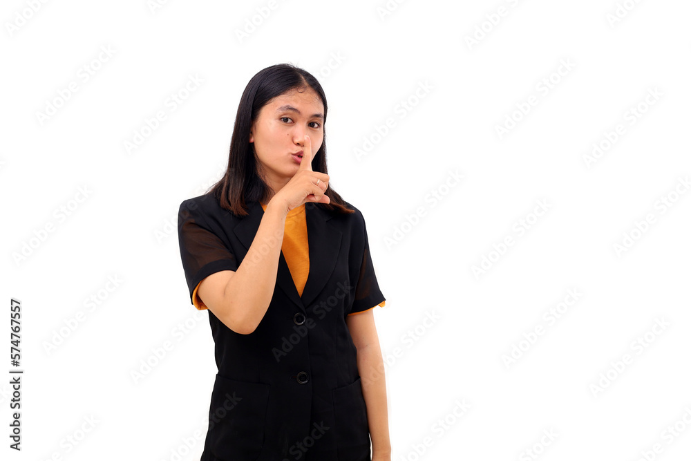Young asian business woman standing while making silence gesture Young asian business woman standing while making silence gesture