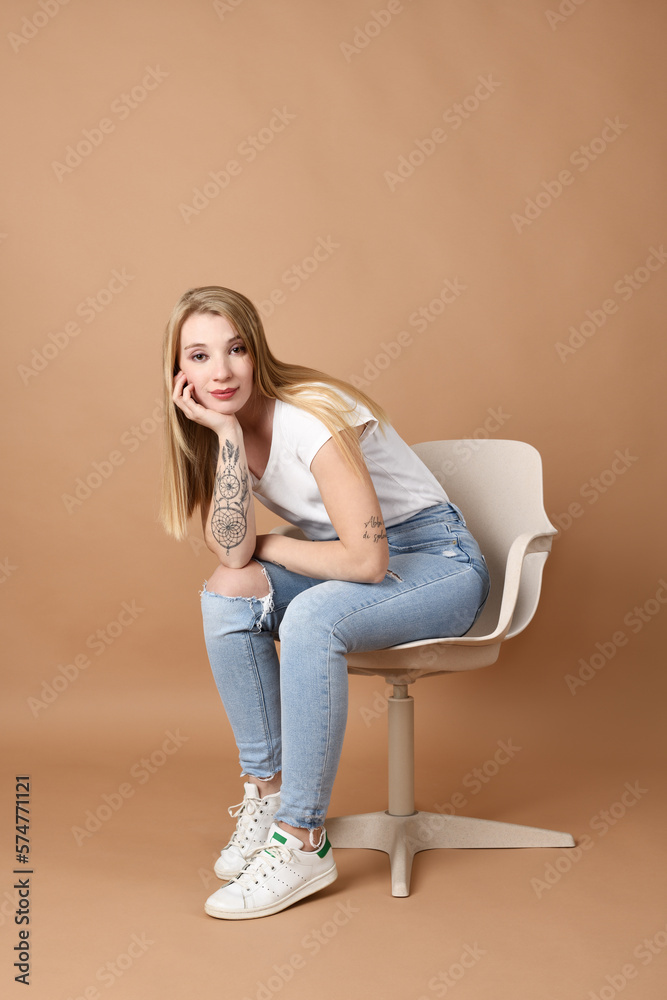 Beautiful blond woman sitting in a chair Beautiful blond woman sitting in a chair