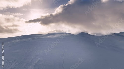 
Skieers in golden winter landscape in mountains