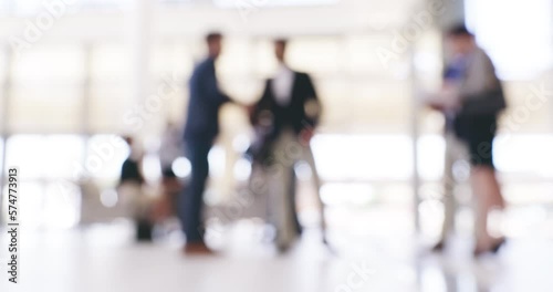 Blur business people in corporate building. Group of people at a conference in a convention centre having a formal greeting in an office workplace. Blurry defocused businessmen shaking hands at work.