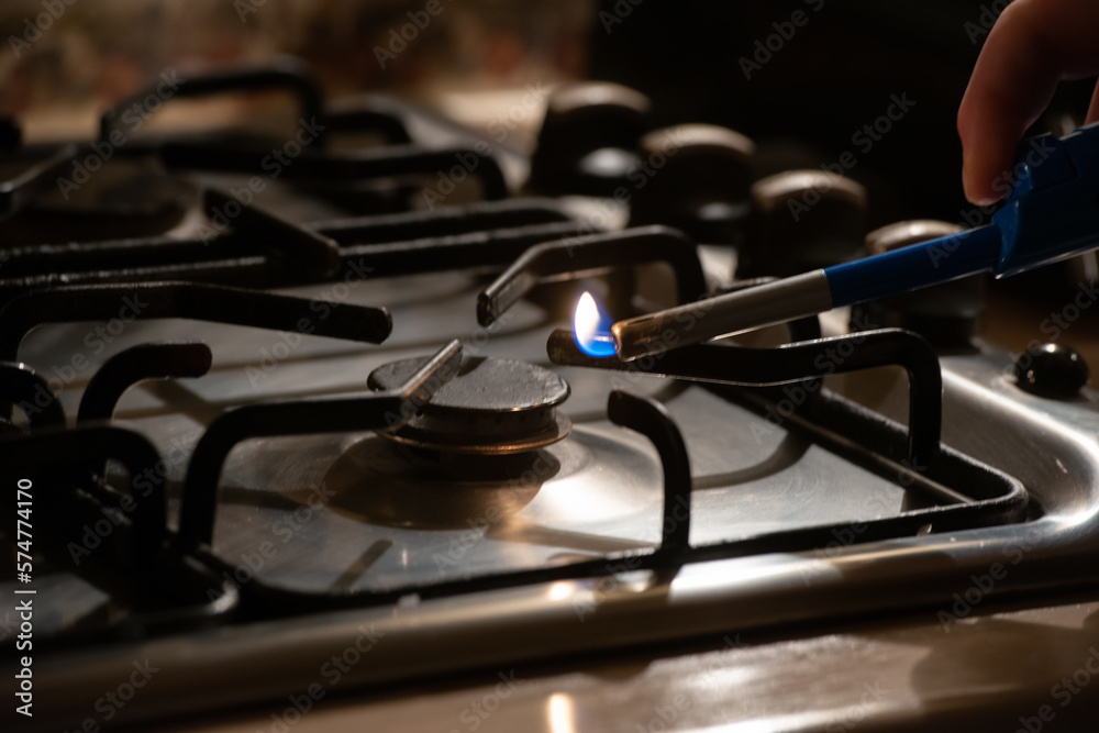 Igniting a gas lighter in a gas stove Stock Photo Adobe Stock