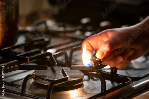 Igniting a gas lighter in a gas stove