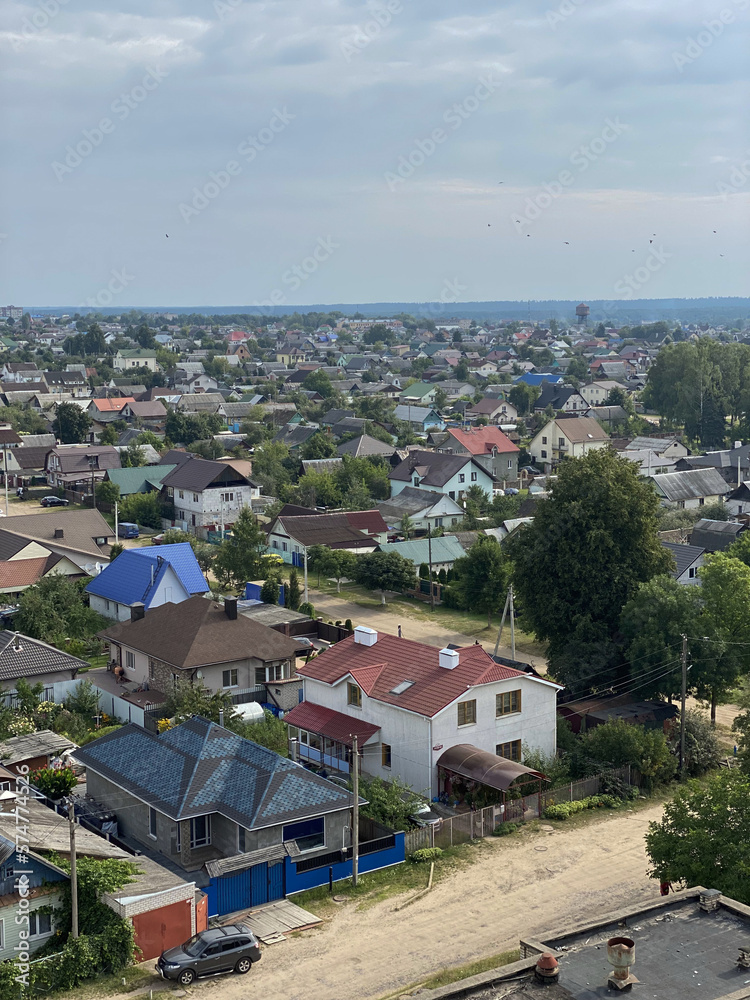 Obraz premium the old part of the city of Belarus, aerial view, summer 2022. Roofs of houses, construction, landscaping of the city, clean air