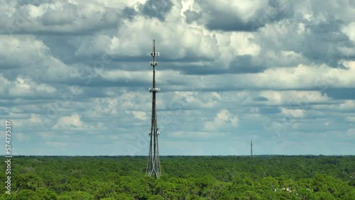 Aerial view of telecommunications cell phone tower with wireless communication 5g antennas for network signal transmission