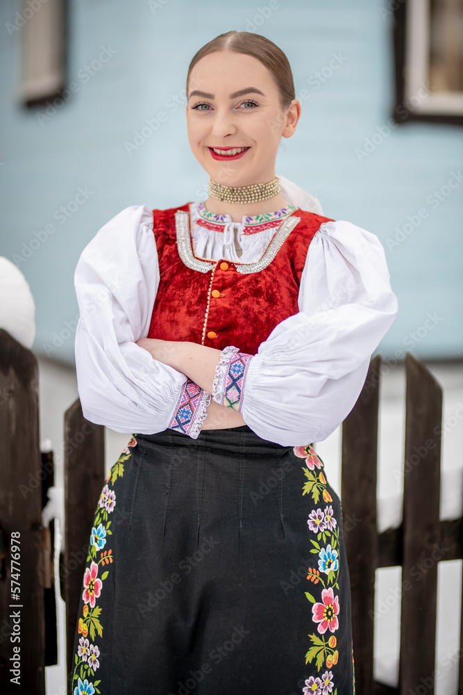 Obraz premium Young beautiful slovak woman in traditional costume. Slovak folklore