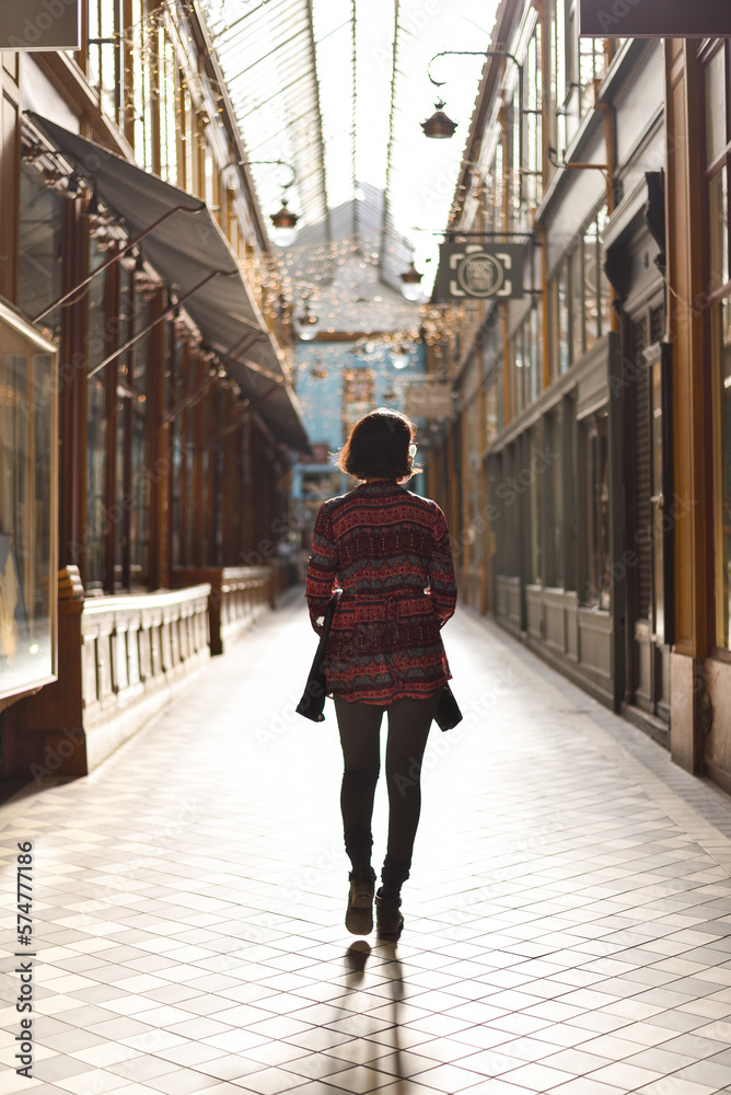 Woman Walking through Passage des Panoramas in Paris, France Woman Walking through Passage des Panoramas in Paris, France