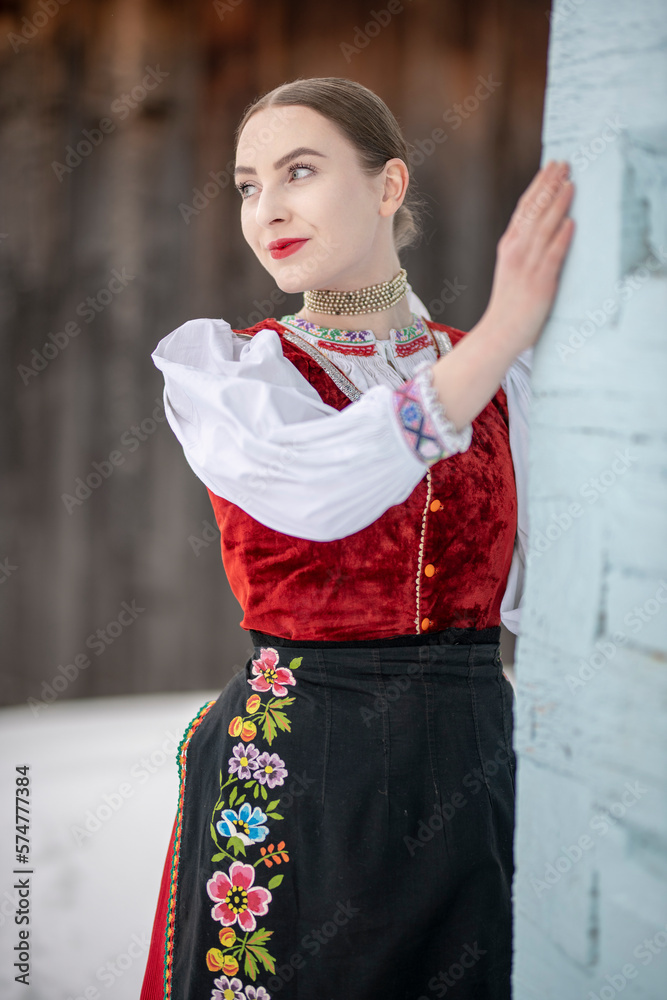 Obraz premium Young beautiful slovak woman in traditional costume. Slovak folklore