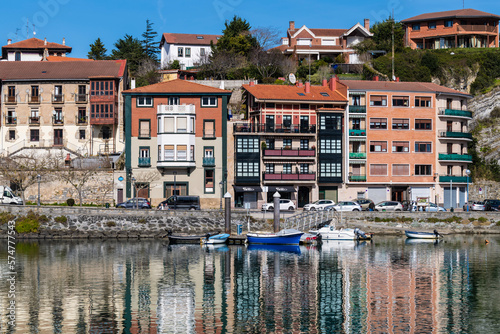 Edificios de viviendas y barcas en la ría de plencia photo