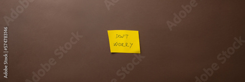 Yellow post it paper with a Dont worry sign on it