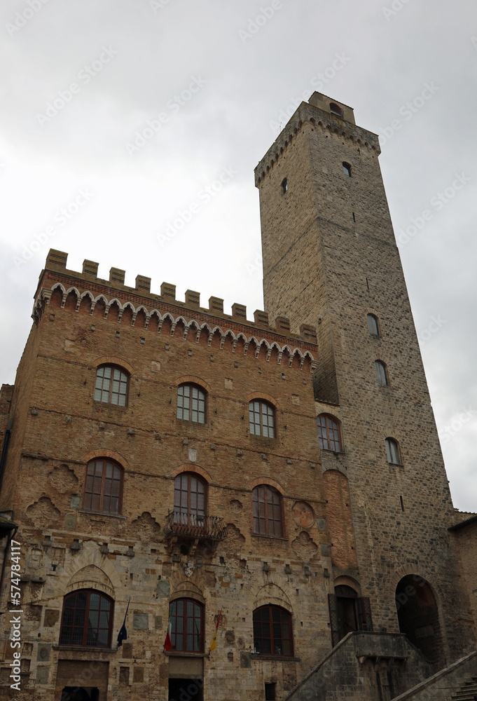 Town hall and medieval tower in the ancient village of San Gimignano in the Tuscany region in Italy