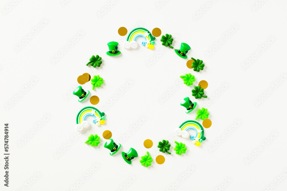 St Particks Day composition. Circle of festive decorations, leprechauns hats, confetti, rainbows on white background. Flat lay, top view. St Particks Day composition. Circle of festive decorations, leprechauns hats, confetti, rainbows on white background. Flat lay, top view.
