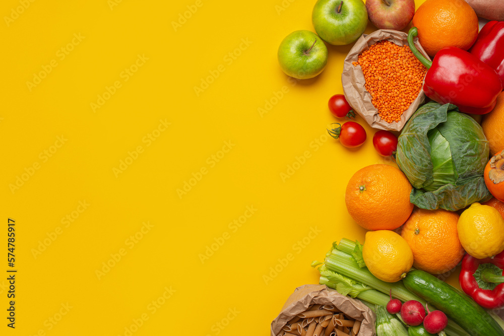 bright vegetables and fruits on a yellow background