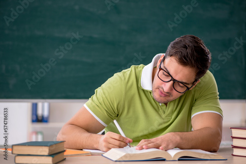 Young male student sitting in the classroom