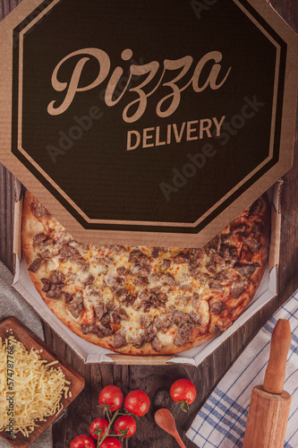 Brazilian pizza with mozzarella, grilled, rump, onion and oregano in a delivery box (Pizza de alcatra) - Top view.