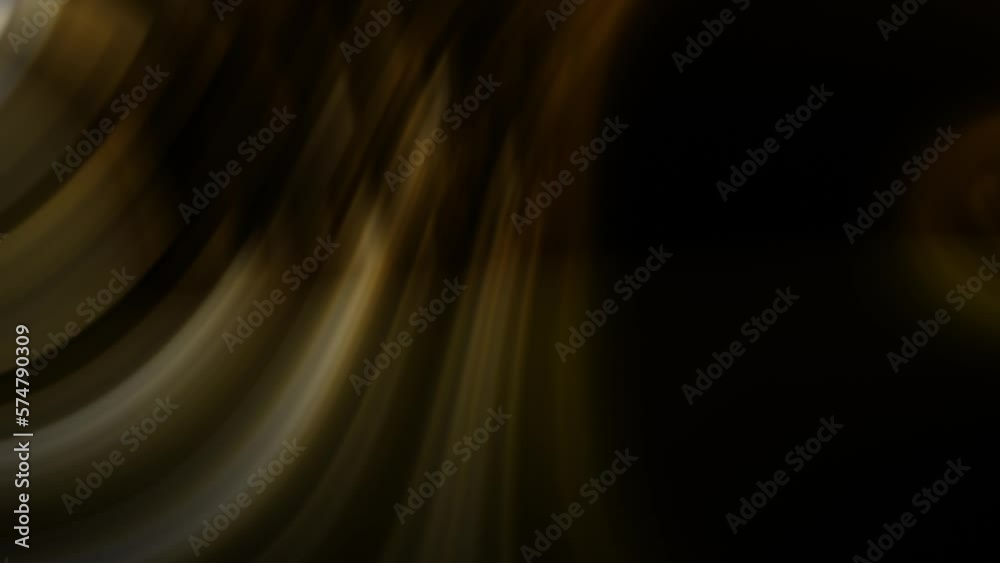 Slow motion brown swoosh shaped strands covering one fourth of the view on a dark backgroud