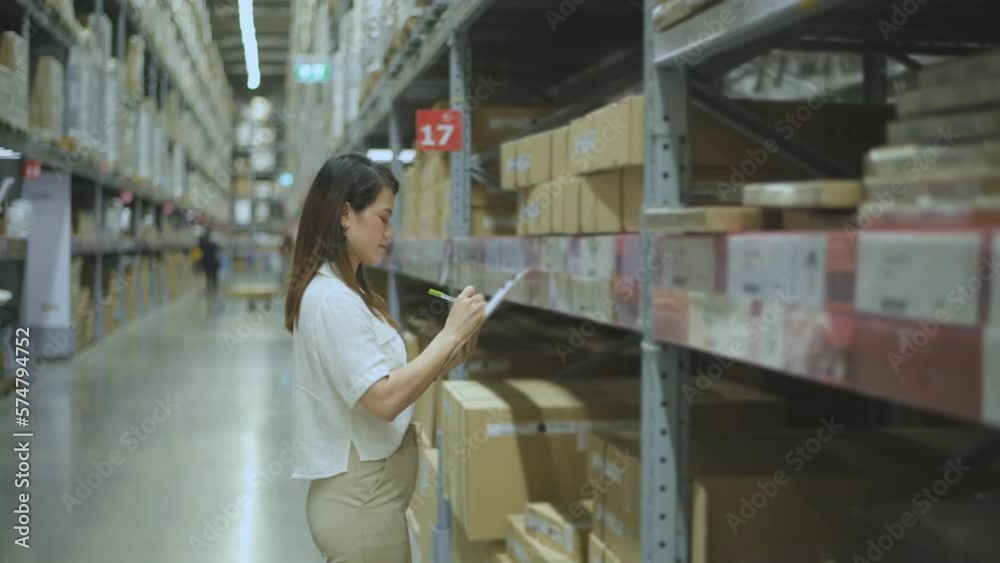 Business concept of 4k Resolution. Asian women intently inspecting items in the warehouse.