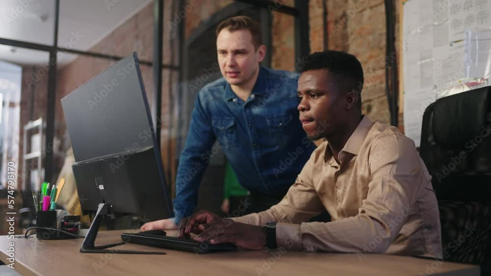 Multiracial Team Of Office Employees Working Together, African Programmer Correcting Code Multiracial Team Of Office Employees Working Together, African Programmer Correcting Code