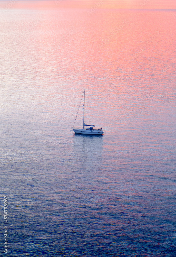 Fototapeta premium Boat in the Sea at Sunset