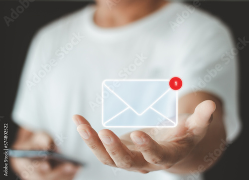 Hand showing Email concept. New email notification for business e-mail communication and digital marketing. Inbox receiving electronic message alert. Email marketing and Contact us by newsletter mail.
