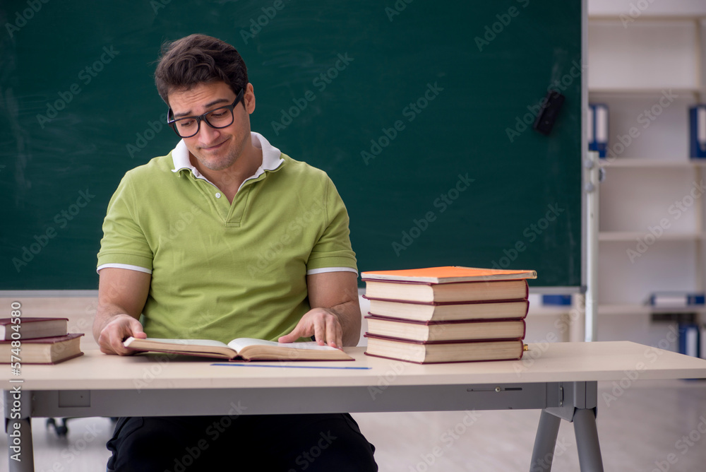 Young male student sitting in the classroom Young male student sitting in the classroom