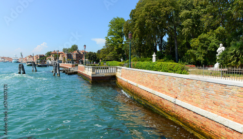 View of the Grand Canal on a hot summer morning. Blue sky, azure water, beautiful architecture of Venice, Italy © opasstudio