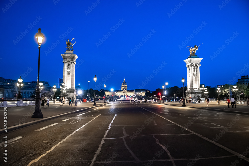 Illuminated Church Dome Of Les Invalides And Bridge Pont Alexandre III In The Night In Paris, France