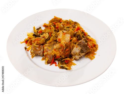 Cabbage stew with smoked pork ribs served in plate. Isolated over white background