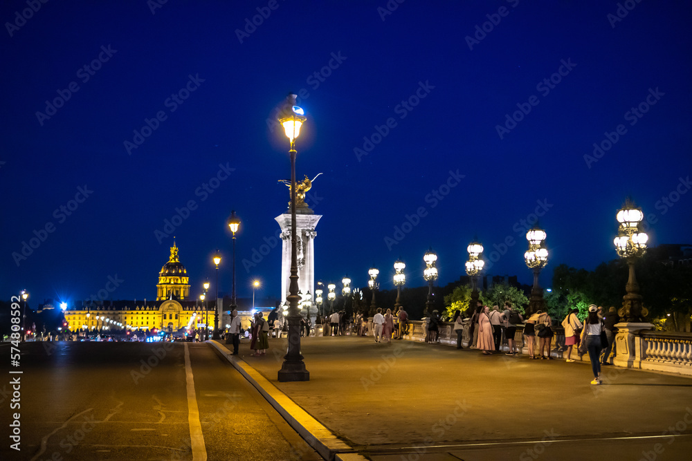 Illuminated Church Dome Of Les Invalides And Bridge Pont Alexandre III In The Night In Paris, France