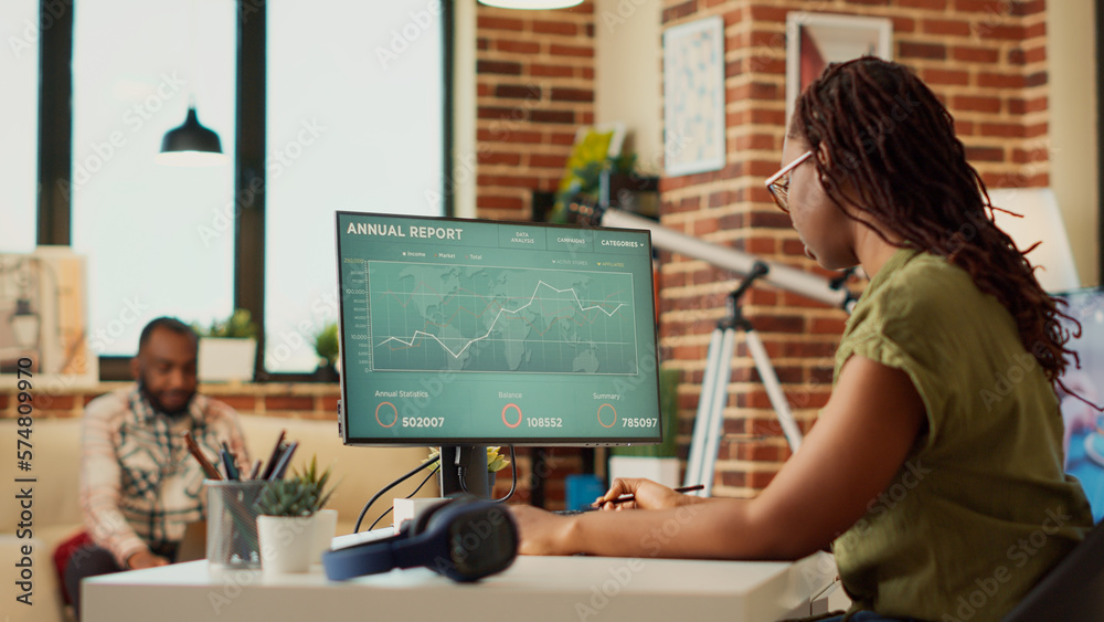 Female employee analyzing financial report on data diagrams, using online web statistics to find sales information. Woman working from home on finance marketing result. Handheld shot. Female employee analyzing financial report on data diagrams, using online web statistics to find sales information. Woman working from home on finance marketing result. Handheld shot.