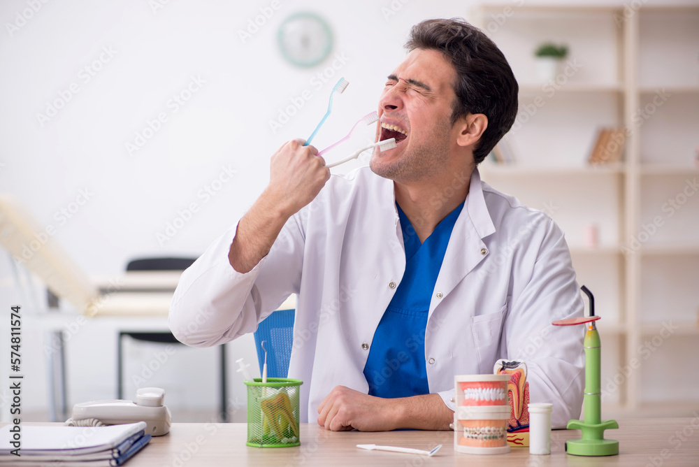 Young male dentist working in the clinic Young male dentist working in the clinic