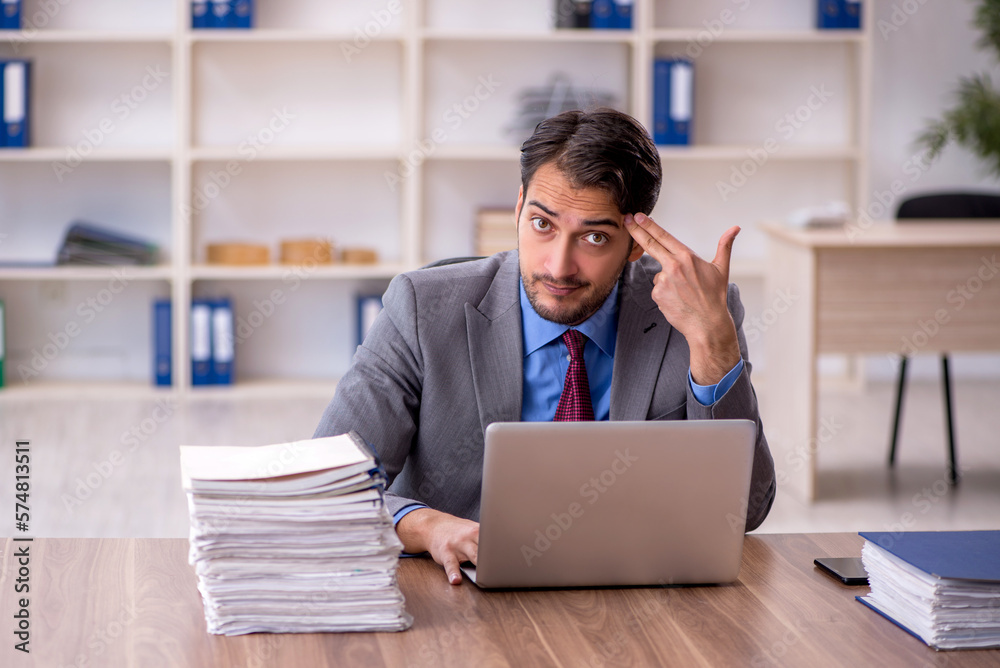 Young male employee working in the office Young male employee working in the office