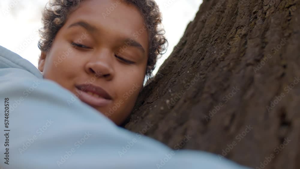 Young happy woman hugging tree with tenderness, love in forest. Realtime Young happy woman hugging tree with tenderness, love in forest. Realtime