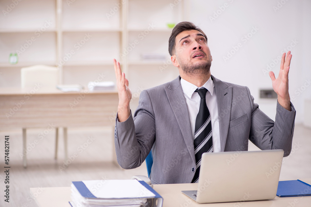 Young male employee working in the office Young male employee working in the office