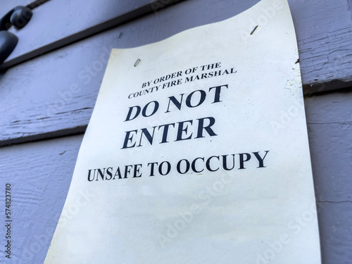 Close up view of a Do Not Enter sign outside a condemned house
