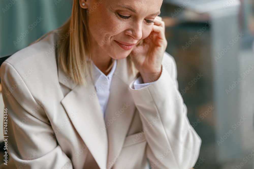 Close up portrait of attractive businesswoman in jacket sitting in cafe Close up portrait of attractive businesswoman in jacket sitting in cafe