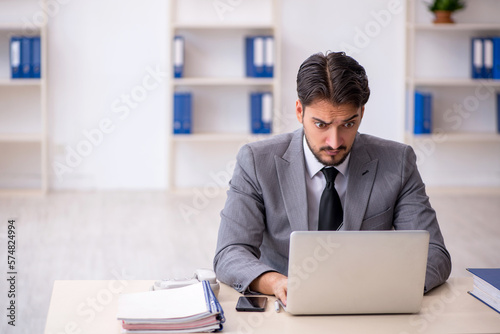 Young male employee working in the office