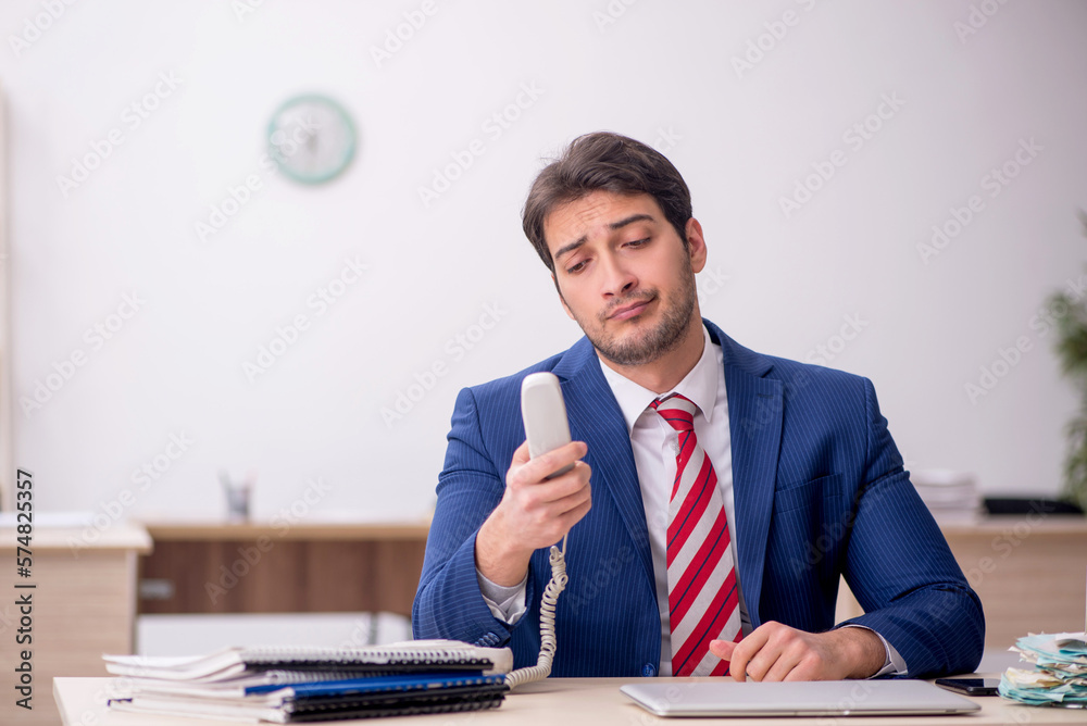 Young male employee working in the office Young male employee working in the office