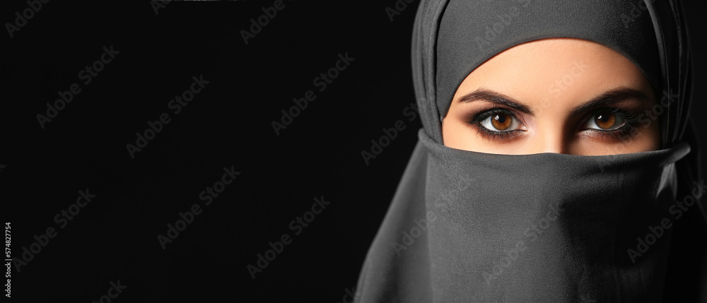 Beautiful Muslim woman on dark background, closeup. Banner for design Beautiful Muslim woman on dark background, closeup. Banner for design