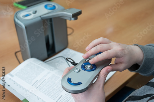 A visually impaired man uses a scanning and reading machine. photo