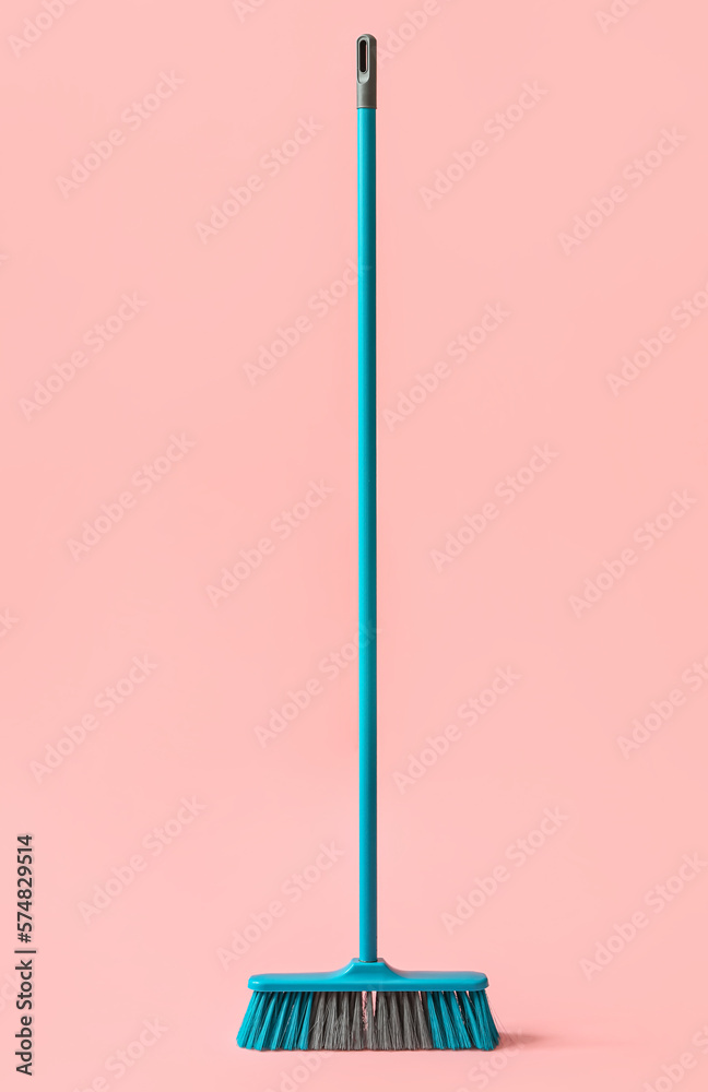 Broom for cleaning on pink background Broom for cleaning on pink background