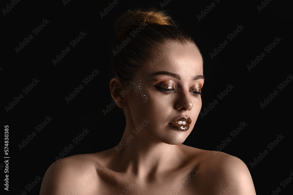 Young woman with golden glitter makeup on black background, closeup Young woman with golden glitter makeup on black background, closeup