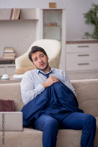 Young male employee working from home during pandemic