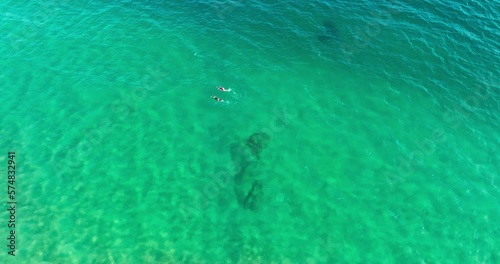 UAV shooting of two people swim leisurely in the sea on holiday, enjoy relaxation and freedom in Riyue Bay, Wanning City, Hainan, China photo