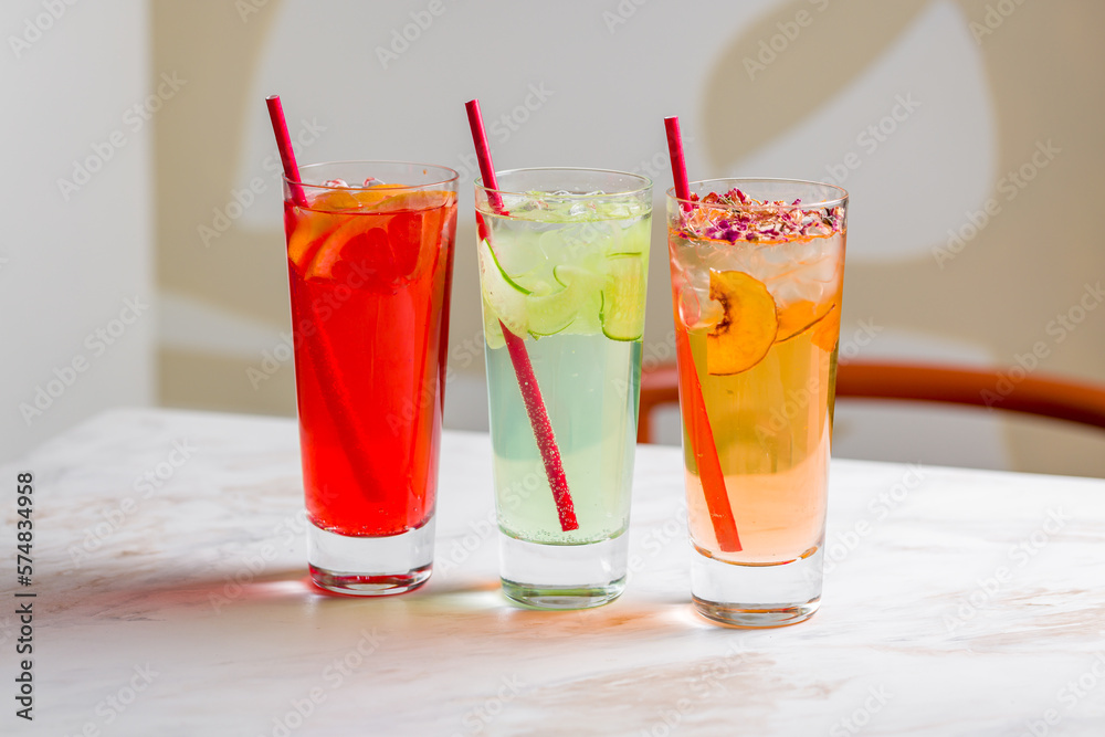 different lemonades in glasses on white marble table different lemonades in glasses on white marble table
