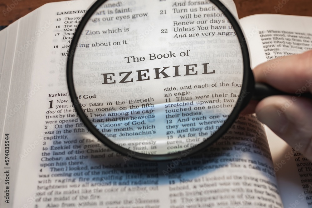 title page book of Ezekiel close up using magnifying glass in the bible