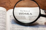 title page book of Hosea close up using magnifying glass in the bible or Torah for faith, christian, hebrew, israelite, history, religion, christianity, Old Testament